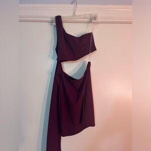 One shoulder burgundy colored dress.